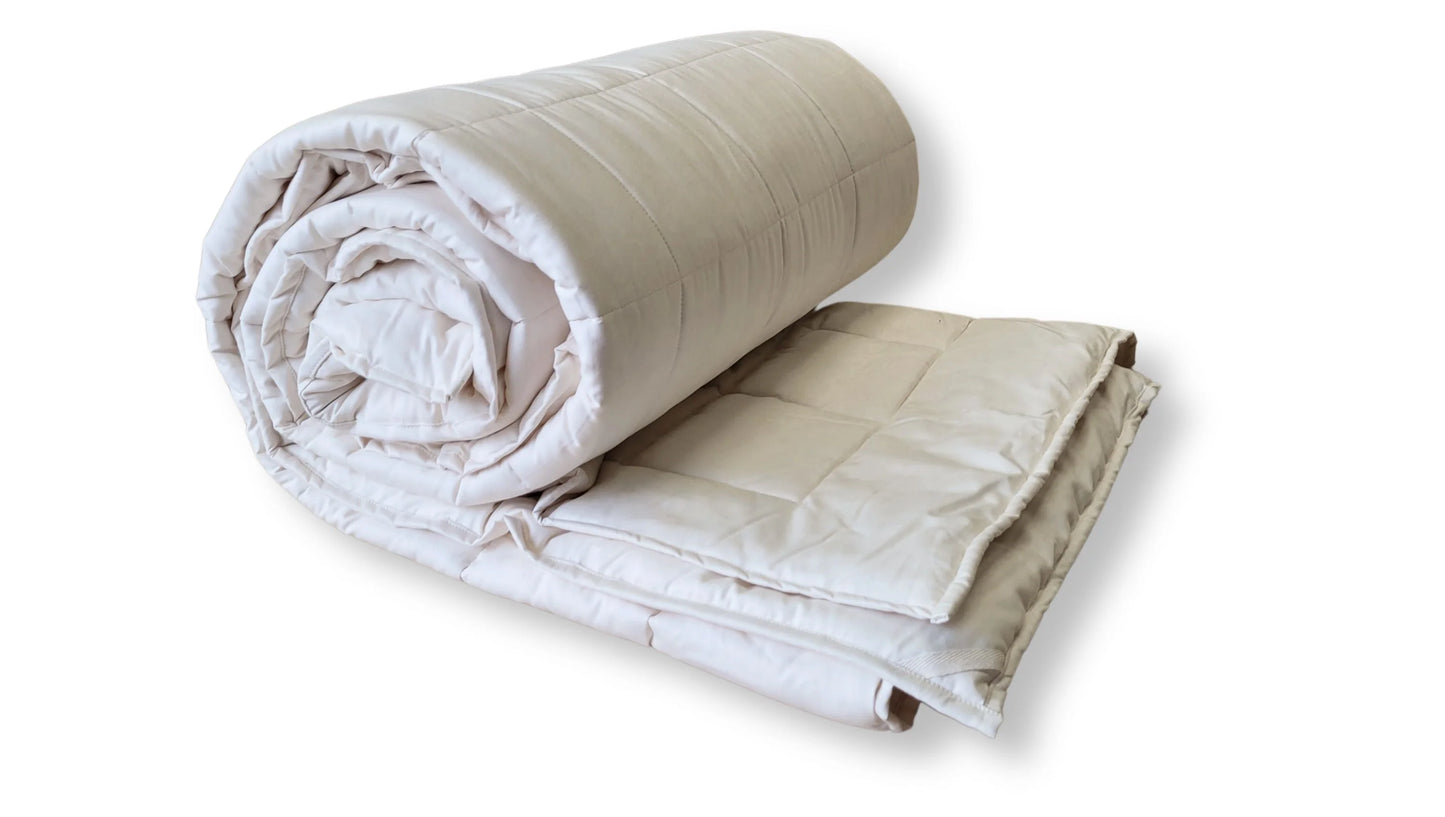 Soaring Heart's quilted organic cotton comforter is designed and crafted for our customers to achieve a restful sleep. The inner filling is made from our blend of certified organic cotton, and encased in a GOTS certified cotton fabric. The artisan quilting pattern keeps everything in place and makes this comforter extremely durable. This comforter is recommended for someone who sleeps cold, or prefers a more weighted comforter.