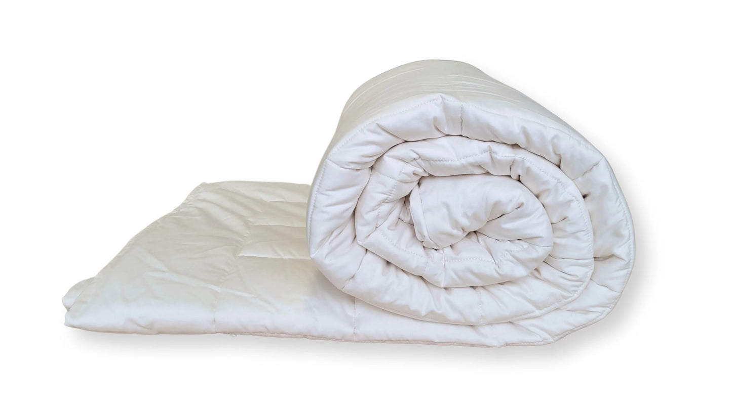 Soaring Heart's quilted organic cotton comforter is designed and crafted for our customers to achieve a restful sleep. The inner filling is made from our blend of certified organic cotton, and encased in a GOTS certified cotton fabric. The artisan quilting pattern keeps everything in place and makes this comforter extremely durable. This comforter is recommended for someone who sleeps cold, or prefers a more weighted comforter.