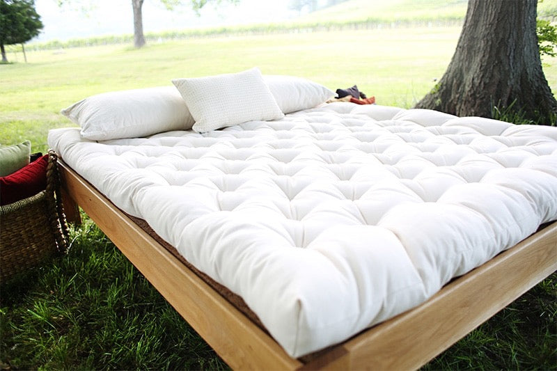 An organic wool mattress hand-made to order
The Pastoral is filled with organic wool batting inside a tufted organic cotton cover. It does not contain latex. The organic wool fiber is resilient, supportive, and promotes a cooler, drier sleep environment. The Pastoral is flexible enough to serve as a futon. Each is handmade and tufted with natural linen thread.