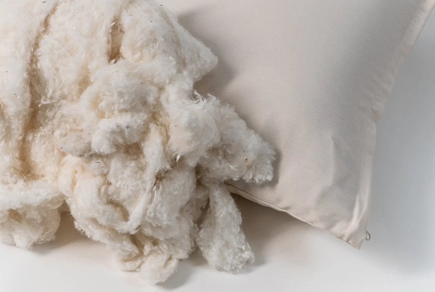 This pillow is made from certified organic cotton batting from the Texas Organic Growers Marketing Co-op. It is covered in organic cotton sateen. This is a great vegan pillow for those who do not want natural latex or wool. This is a firmer feeling pillow. Comes with a zipper so you can add or remove filling.