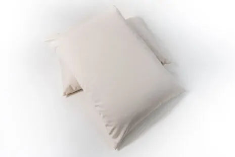 This pillow is made from certified organic wool and is covered in organic cotton sateen. Wool will not compress as much over time as an organic cotton pillow. Wicks away moisture on hot nights to help keep you cool and insulates on cool nights. Spot clean only. Comes with a zipper so you can add or remove filling.