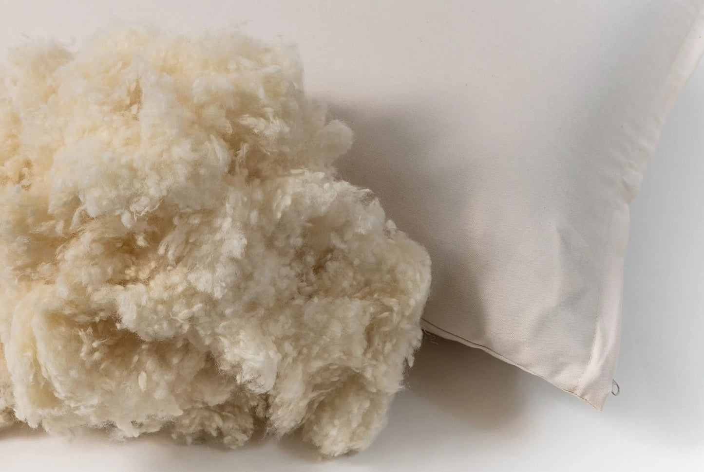 This pillow is made from small natural wool fluffs that stick to each other. You can move around the soft little balls of wool to shape it however it will best fit your neck and head. For example you can squish it around to create a thicker roll to support your neck and an indentation for your head or just a level surface. Comes with a zipper so you can add or remove filling. Can be ordered in three thicknesses, this is one of our most versatile pillows!