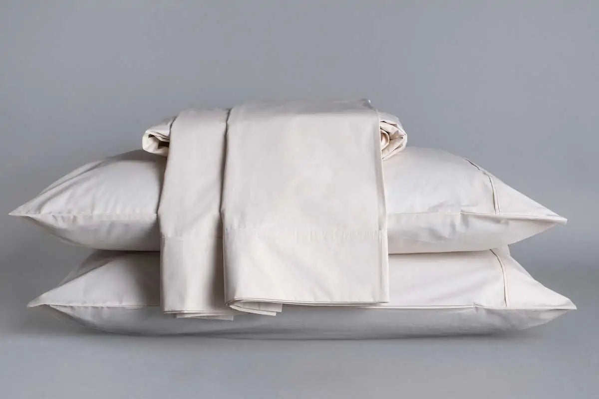 Immerse yourself in the pure, cooling comfort of our Sleep and Beyond Organic Sheets, spun from 100% GOTS certified organic cotton percale. Delight in the light, airy touch of our sheets, available in classic white or elegant natural ivory. Crafted with a 300-thread count for a perfect blend of breathability, crispness, and long-lasting durability, these sheets promise to transform your sleep experience.