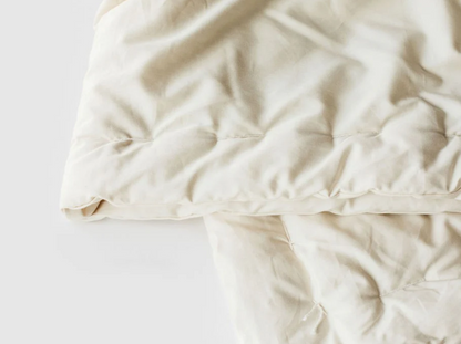 Designed to cater to individual sleep temperature needs, our innovative Natural Dual Weight Comforter will help alleviate the “too hot vs. too cold” discussion in your bedroom. Handcrafted to provide individualized comfort, warmth, and coziness. 

Handcrafted for comfort, warmth, and coziness, our Dual Weight Comforter is made from sustainably and locally sourced premium eco wool and encased in GOTS-certified organic cotton sateen. Hand-tufted and stitched around the perimeter so the wool batting stays in p