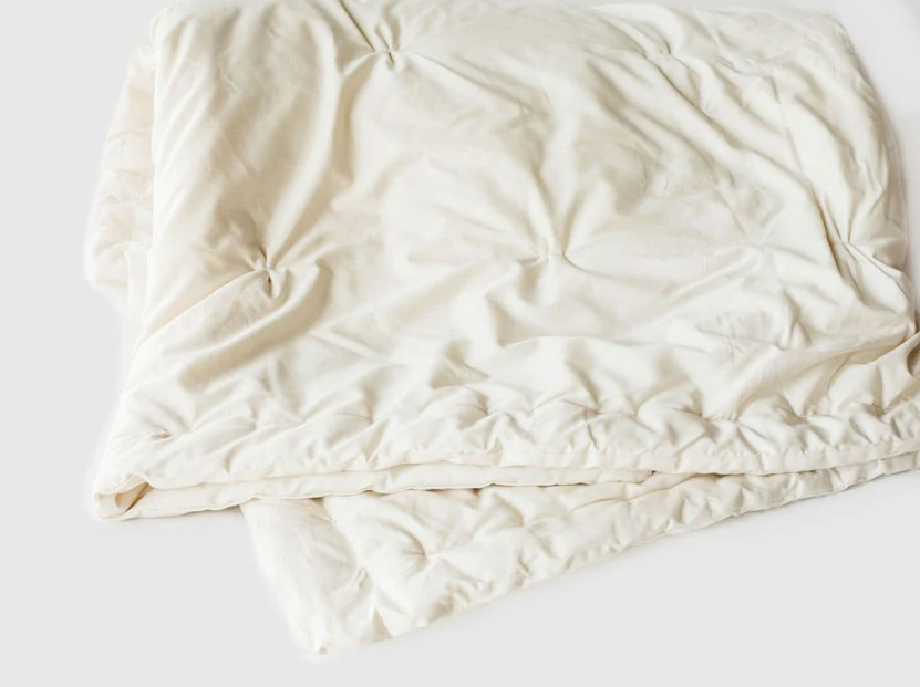 Designed to cater to individual sleep temperature needs, our innovative Natural Dual Weight Comforter will help alleviate the “too hot vs. too cold” discussion in your bedroom. Handcrafted to provide individualized comfort, warmth, and coziness. 

Handcrafted for comfort, warmth, and coziness, our Dual Weight Comforter is made from sustainably and locally sourced premium eco wool and encased in GOTS-certified organic cotton sateen. Hand-tufted and stitched around the perimeter so the wool batting stays in p