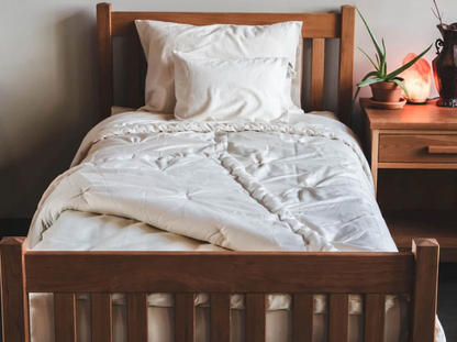 Stitched with care, you get warmth, temperature regulation, and breathability in this signature handmade product. Designed and handcrafted for comfort and coziness, our quilted comforters are made from domestically sourced premium eco wool encased in an organic cotton sateen shell. Hand-tufted and stitched around the perimeter so the wool batting stays in place. Now with corner ties for securing into your duvet cover. These comforters naturally regulate body temperature while wicking away moisture, ensuring
