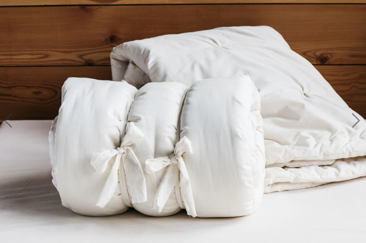 Stitched with care, you get warmth, temperature regulation, and breathability in this signature handmade product. Designed and handcrafted for comfort and coziness, our quilted comforters are made from domestically sourced premium eco wool encased in an organic cotton sateen shell. Hand-tufted and stitched around the perimeter so the wool batting stays in place. Now with corner ties for securing into your duvet cover. These comforters naturally regulate body temperature while wicking away moisture, ensuring