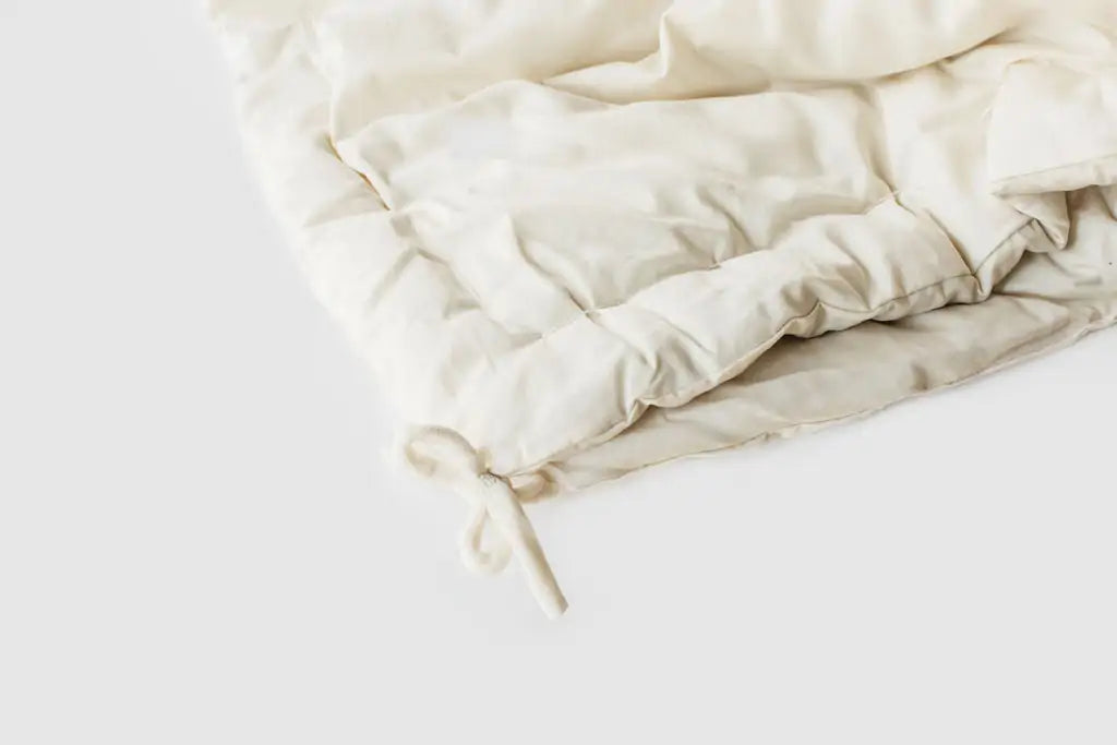The perfect option to carry you through all four seasons.Two comforters, each slightly lighter than our Light weight, joined together with cotton ties at the corners and on the sides. Tie the layers together in colder weather, separate them as the temperature warms. Fits insidea duvet cover with ease. Designed and handcrafted for comfort, warmth, and coziness, our quilted comforters are made from domestically sourced premium eco wool encased in an organic cotton sateen shell.