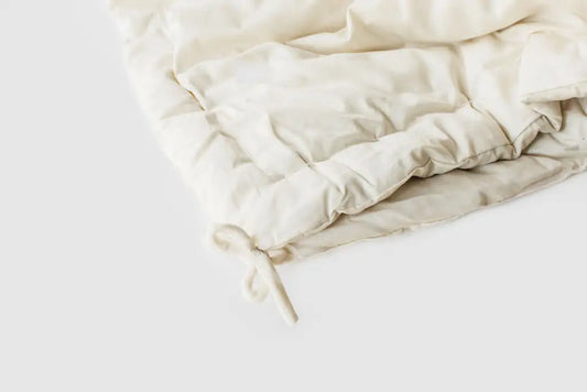 The perfect option to carry you through all four seasons.Two comforters, each slightly lighter than our Light weight, joined together with cotton ties at the corners and on the sides. Tie the layers together in colder weather, separate them as the temperature warms. Fits insidea duvet cover with ease. Designed and handcrafted for comfort, warmth, and coziness, our quilted comforters are made from domestically sourced premium eco wool encased in an organic cotton sateen shell.