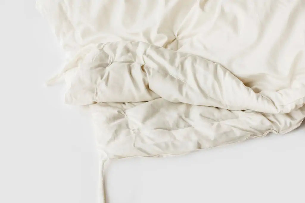 The perfect option to carry you through all four seasons.Two comforters, each slightly lighter than our Light weight, joined together with cotton ties at the corners and on the sides. Tie the layers together in colder weather, separate them as the temperature warms. Fits insidea duvet cover with ease. Designed and handcrafted for comfort, warmth, and coziness, our quilted comforters are made from domestically sourced premium eco wool encased in an organic cotton sateen shell. Hand-tufted and stitched around
