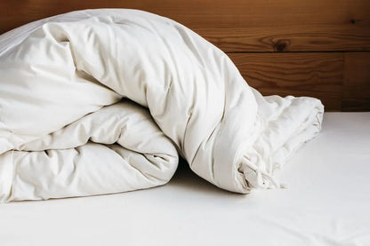 The perfect option to carry you through all four seasons.Two comforters, each slightly lighter than our Light weight, joined together with cotton ties at the corners and on the sides. Tie the layers together in colder weather, separate them as the temperature warms. Fits insidea duvet cover with ease. Designed and handcrafted for comfort, warmth, and coziness, our quilted comforters are made from domestically sourced premium eco wool encased in an organic cotton sateen shell. Hand-tufted and stitched around