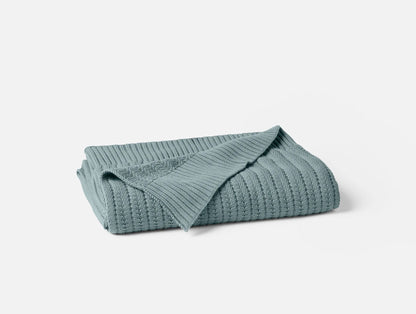 Our Casa Loma Organic Throw is made with the finest organic cotton, ensuring a warm and comforting experience. The unique fishbone stitch enhances the throw's beautiful drape and natural softness, while the 2X2 ribbed hem adds a touch of elegance. The result is a cozy and breathable throw that cocoons you in its calming embrace.