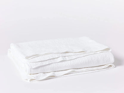 Crafted in Portugal from exceptionally fine yarns, this matelass√© blanket pairs a light, lofty feel with a high performance, stitched texture. Inspired by quilted kantha cloth, each blanket is stonewashed to enhance the raw beauty and softness of rumpled organic cotton. Finished with a simple bound edge for heirloom detail and effortless layering.