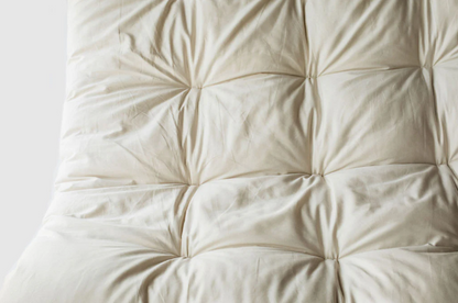 Encased in GOTS-certified organic cotton sateen and filled with GOTS-certified wool, our quilted toppers are designed to sit atop your existing mattress. With organic wool sustainably sourced from New Zealand, these toppers provide a comfortable, breathable sleep surface that naturally regulates body temperature. Adding a topper allows you to fine-tune your sleep system to your comfort preference.