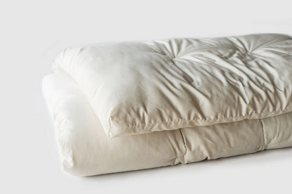 Encased in GOTS-certified organic cotton sateen and filled with GOTS-certified wool, our quilted toppers are designed to sit atop your existing mattress. With organic wool sustainably sourced from New Zealand, these toppers provide a comfortable, breathable sleep surface that naturally regulates body temperature. Adding a topper allows you to fine-tune your sleep system to your comfort preference.