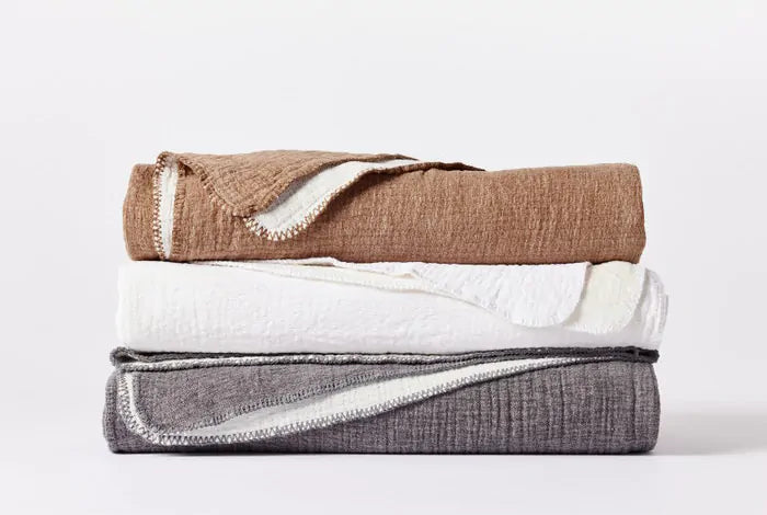 Indulge in luxurious comfort with the Coyuchi Cozy Cotton blanket, harmonizing plush chenille with lightweight organic cotton for a delicately puckered texture. Each color reverses to white, offering versatile decoration options. Crafted from 100% organic cotton, sourced in Turkey and expertly woven in Germany, this blanket promises both elegance and ease with its machine-washable design (please refer to washing instructions).
