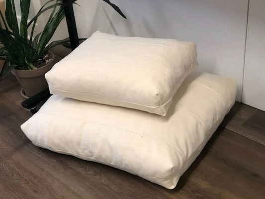 Our new pet bed was redesigned with your pets happiness and comfort in mind. 

Our pet beds are part of our ReKindle program, created using 5" - 9" wide strips of our leftover wool moisture barrier stitched together to create a pieced fabric. This product efficiently utilizes materials left over from the production of our larger items, in keeping with our zero-waste philosophy.

Each pet bed is filled with a generous amount of GOTS Certified Organic Cotton batting. The batting will slightly settle overtime,