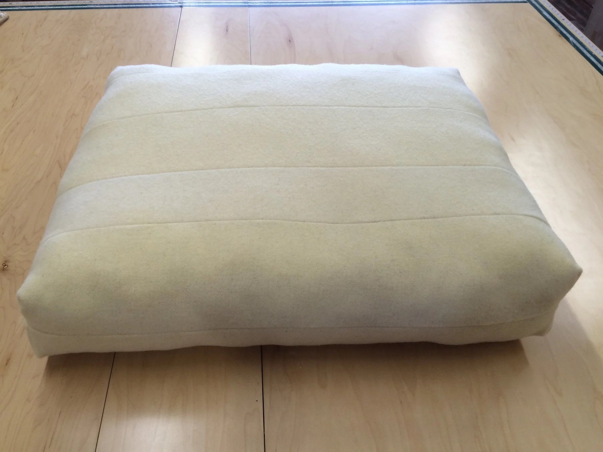 Our new pet bed was redesigned with your pets happiness and comfort in mind. 

Our pet beds are part of our ReKindle program, created using 5" - 9" wide strips of our leftover wool moisture barrier stitched together to create a pieced fabric. This product efficiently utilizes materials left over from the production of our larger items, in keeping with our zero-waste philosophy.

Each pet bed is filled with a generous amount of GOTS Certified Organic Cotton batting. The batting will slightly settle overtime,