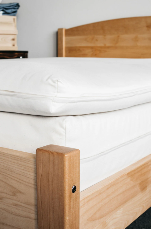 Elevate your sleep experience with our cushiony, all-natural mattress topper created from the purest latex wrapped in the finest wool. The best of both worlds in one luxurious package. The topper is made with 2" of GOLS-certified Dunlop latex, wrapped in our exceptional Premium Eco Wool and encased in GOTS-certified organic cotton sateen. The result is a 3"-deep topper that's super comfortable, durable, and free of chemicals and synthetic additives. The topper is rated an ILD of 25, or "soft."

This product