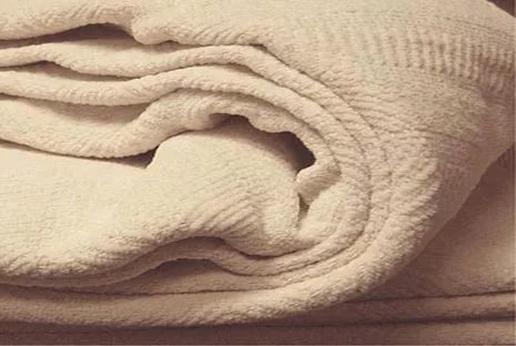 Indulge in the comforting embrace of the Organics And More Organic Cotton Chenille blanket. Meticulously crafted with hemmed edges and a charming herringbone pattern, this mid-weight blanket offers both texture and warmth. Made from GOTS certified organic cotton in a soothing ivory hue, it’s not only machine washable but also gets softer with every wash. Enjoy the durability and cozy comfort of this healthy alternative to conventional cotton blankets.