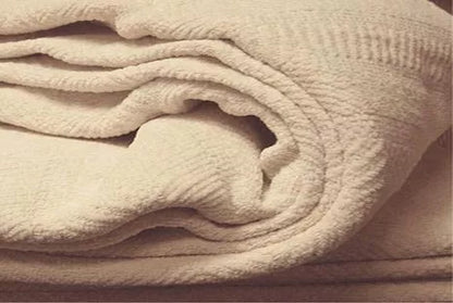 Indulge in the comforting embrace of the Organics And More Organic Cotton Chenille blanket. Meticulously crafted with hemmed edges and a charming herringbone pattern, this mid-weight blanket offers both texture and warmth. Made from GOTS certified organic cotton in a soothing ivory hue, it’s not only machine washable but also gets softer with every wash. Enjoy the durability and cozy comfort of this healthy alternative to conventional cotton blankets.
