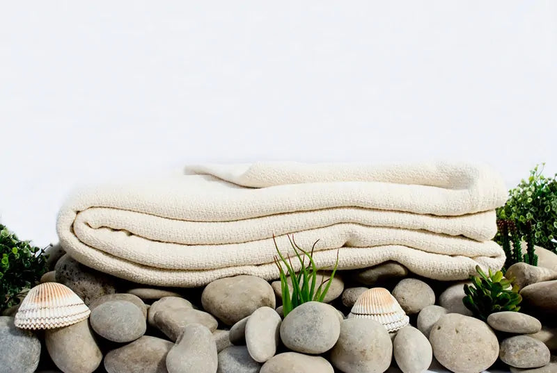 Crafted from GOTS certified organic cotton, the Crepe Weave Blanket by Organics and More offers timeless appeal with its simple yet elegant design. Never dyed or treated, this blanket provides a healthy and attractive bedding option. Lightweight and versatile, it’s ideal for both cool summer nights and winter layering. Skillfully constructed with hemmed edges, it withstands repeated washes while maintaining its quality. Available in a natural ivory color, this blanket exudes understated beauty and eco-frien