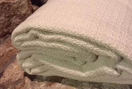 Crafted from GOTS certified organic cotton, the Crepe Weave Blanket by Organics and More offers timeless appeal with its simple yet elegant design. Never dyed or treated, this blanket provides a healthy and attractive bedding option. Lightweight and versatile, it’s ideal for both cool summer nights and winter layering. Skillfully constructed with hemmed edges, it withstands repeated washes while maintaining its quality. Available in a natural ivory color, this blanket exudes understated beauty and eco-frien