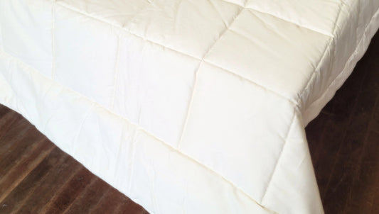 Soaring Heart's quilted organic cotton comforter is designed and crafted for our customers to achieve a restful sleep. The inner filling is made from our blend of certified organic cotton, and encased in a GOTS certified cotton fabric. The artisan quilting pattern keeps everything in place and makes this comforter extremely durable. This comforter is recommended for someone who sleeps cold, or prefers a more weighted comforter.