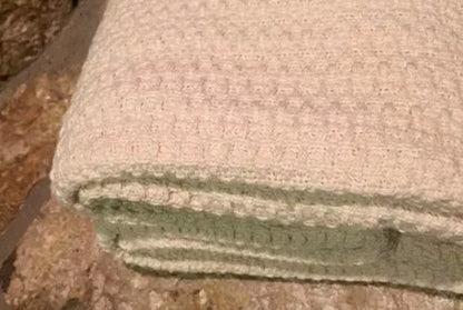 Experience year-round comfort with our Organic Waffle Weave Blanket, featuring a soft, lightweight design for cozy versatility. Crafted from GOTS certified organic cotton, this blanket offers both style and sustainability. Its loose waffle weave provides enhanced flexibility and breathability, perfect for all seasons. Whether draped over your bed or used as a stylish throw, its natural ivory color and hemmed edges add a touch of elegance to any space. Plus, it’s conveniently machine washable for easy care.