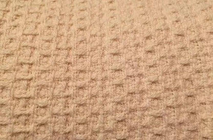 Experience year-round comfort with our Organic Waffle Weave Blanket, featuring a soft, lightweight design for cozy versatility. Crafted from GOTS certified organic cotton, this blanket offers both style and sustainability. Its loose waffle weave provides enhanced flexibility and breathability, perfect for all seasons. Whether draped over your bed or used as a stylish throw, its natural ivory color and hemmed edges add a touch of elegance to any space. Plus, it’s conveniently machine washable for easy care.