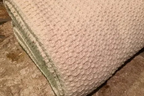 Experience year-round comfort with our Organic Waffle Weave Blanket, featuring a soft, lightweight design for cozy versatility. Crafted from GOTS certified organic cotton, this blanket offers both style and sustainability. Its loose waffle weave provides enhanced flexibility and breathability, perfect for all seasons. Whether draped over your bed or used as a stylish throw, its natural ivory color and hemmed edges add a touch of elegance to any space. Plus, it’s conveniently machine washable for easy care.