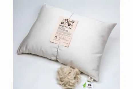 This pillow is made from soft silky kapok covered in organic cotton sateen. Kapok is a silky fiber, and feels much like milkweed or down. It is harvested from the seed pods of a kapok tree (the tree is never cut down). This natural pillow will compress with use but can be placed dry in a hot dryer for 10 minutes to help plump the pillow. This is our softest feeling pillow. Comes with a zipper so you can add or remove filling.