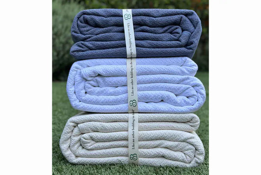 Wrap yourself in comfort with our exquisitely crafted blanket featuring a timeless jacquard weave. Made from GOTS certified 100% cotton, this weighty and durable blanket is not only pleasingly substantial but also free of harmful chemicals and dyes, ensuring a safe and cozy sleep experience. Its substantial texture provides warmth and comfort, making it ideal for use throughout all four seasons. Available in three elegant color options, this blanket effortlessly complements any bedroom decor, adding a touch