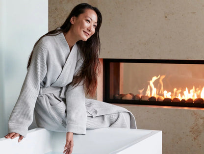 An airy waffle weave wraps you in the natural comfort and performance of premium organic cotton. Pre-tumbled to be soft from day one, this elevated spa robe feels light and breathable, growing more supple with every wash. Unisex styling creates a streamlined fit that adjusts with double belt-loops and a self-tie. Spacious patch pockets at hip.