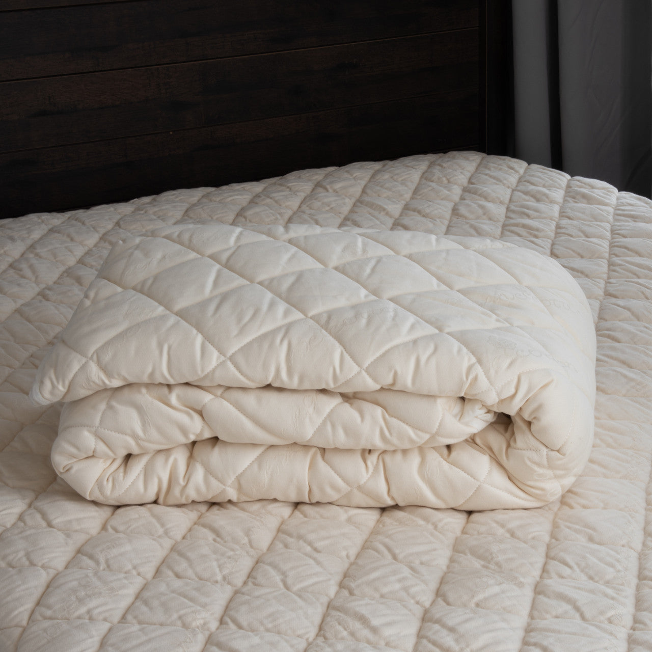 The washable wool mattress pad is made of our American Dream Wool and quilted using organic cotton on both sides. It provides excellent protection to your mattress. The washable wool pad is skirted with organic cotton knit and features an 18" pocket. It will keep your mattress looking newer longer. Made in the USA.